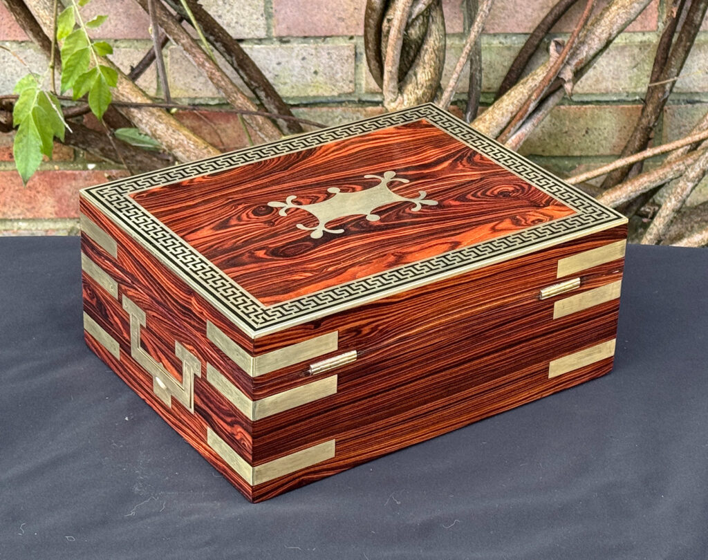 Rear right view of an antique jewellery box in kingwood with brass inlay.