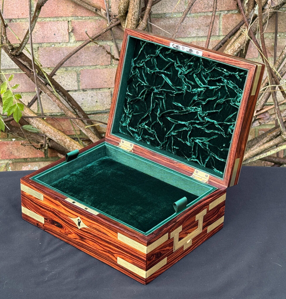 Front right interior view of an antique jewellery box in kingwood with brass inlay.