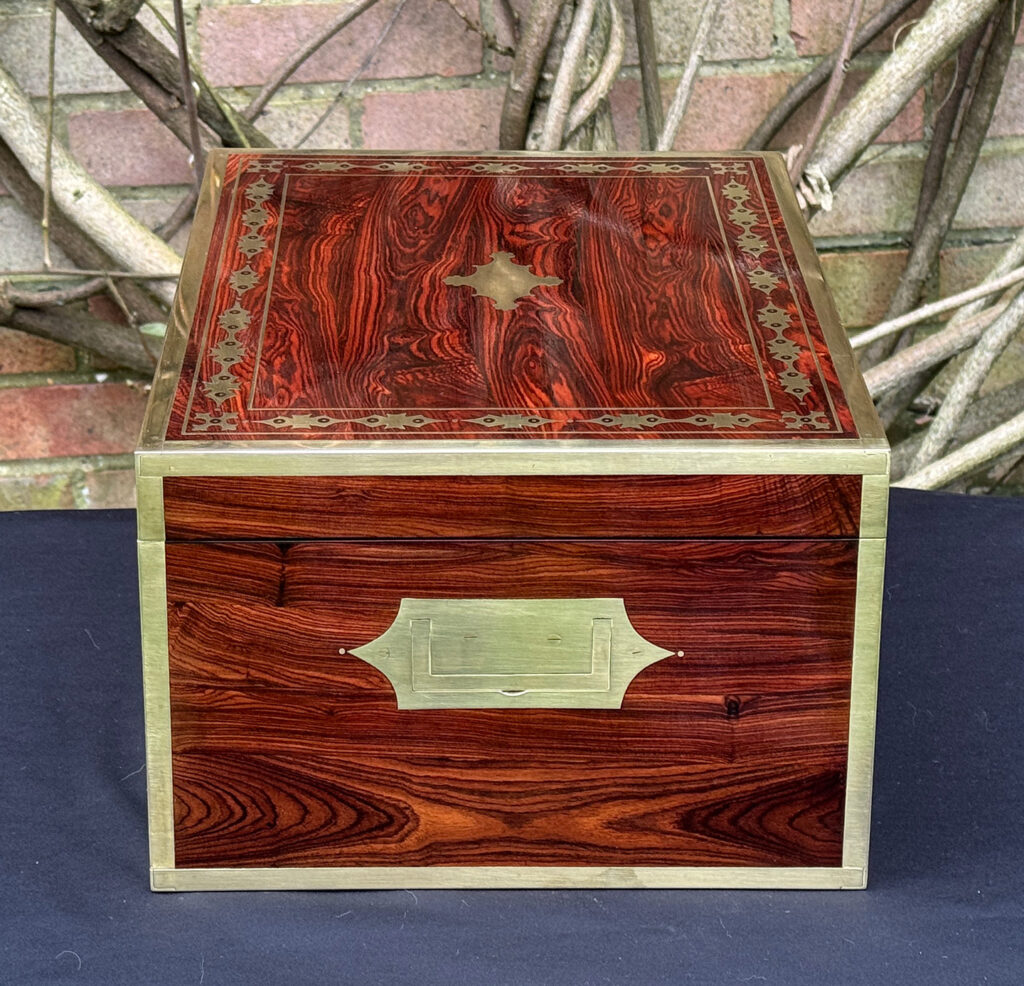 Right side view of an antique jewellery box in kingwood with decorative brass inlay.