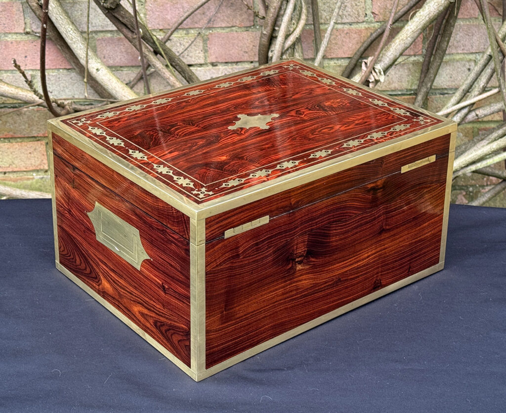 Rear right view of an antique jewellery box in kingwood with decorative brass inlay.