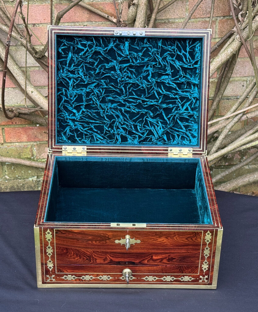 Front internal view of an antique jewellery box in kingwood with decorative brass inlay.