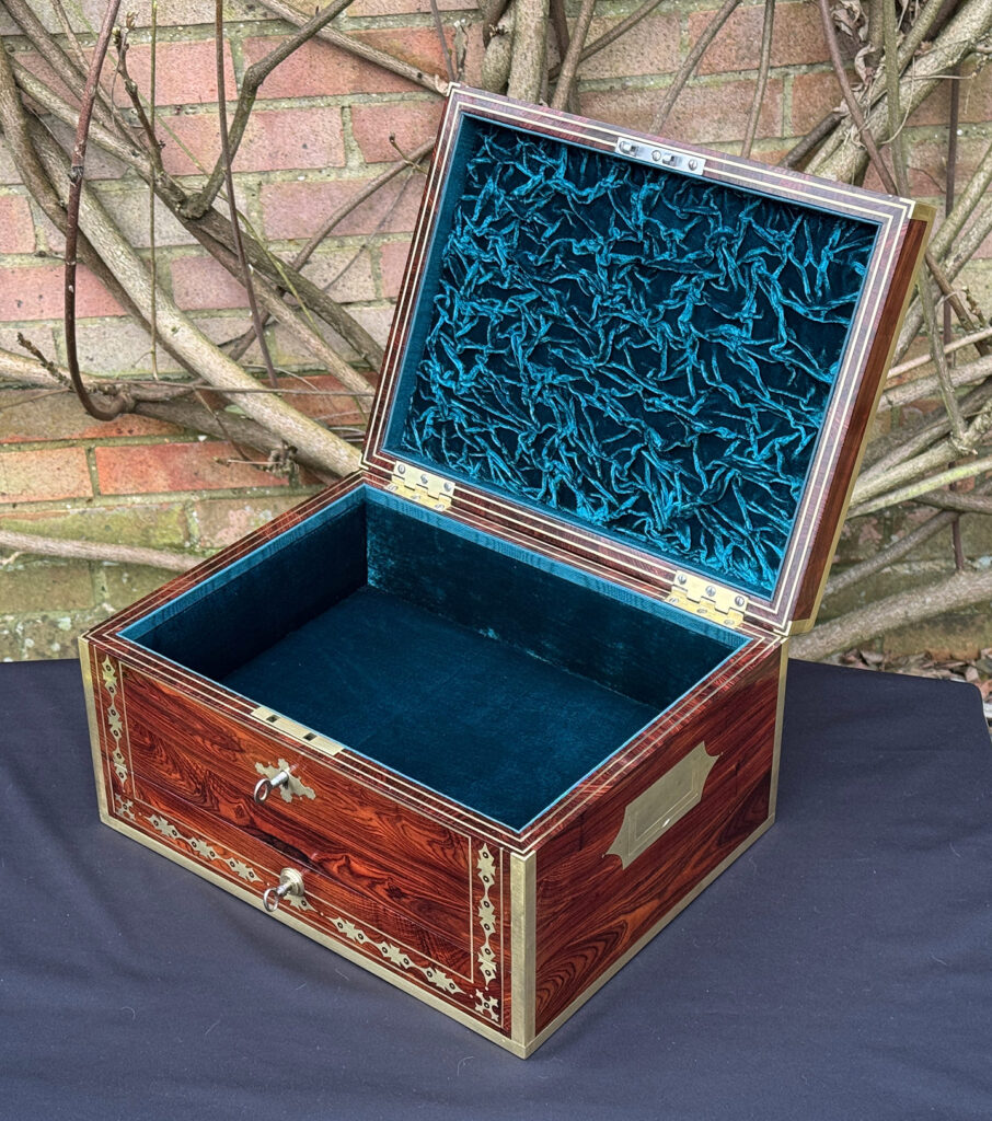 Front right internal view of an antique jewellery box in kingwood with decorative brass inlay.
