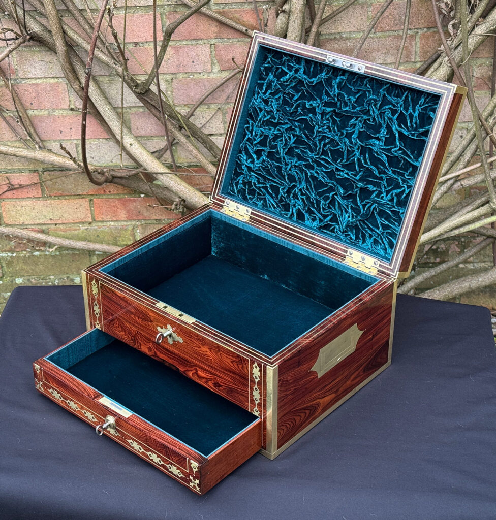 Front right internal view of an antique jewellery box in kingwood with decorative brass inlay.