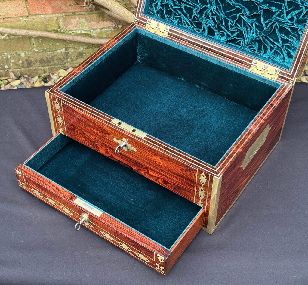 Closer internal view of an antique jewellery box in kingwood with decorative brass inlay.