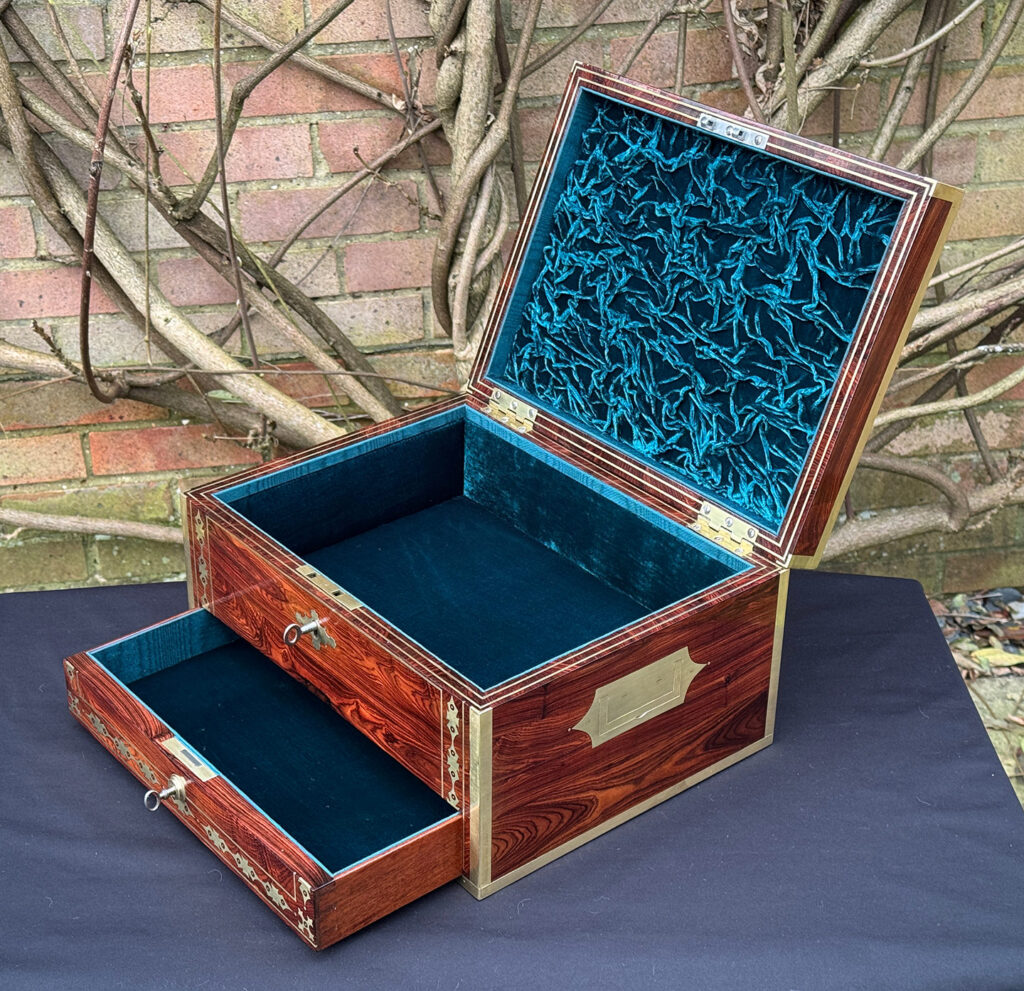 Right side internal view of an antique jewellery box in kingwood with decorative brass inlay.