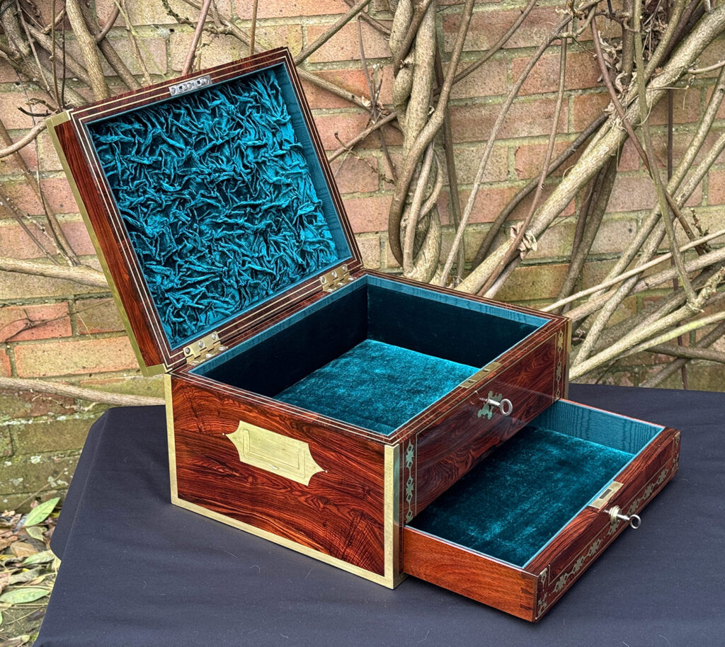 Left side internal view of an antique jewellery box in kingwood with decorative brass inlay.