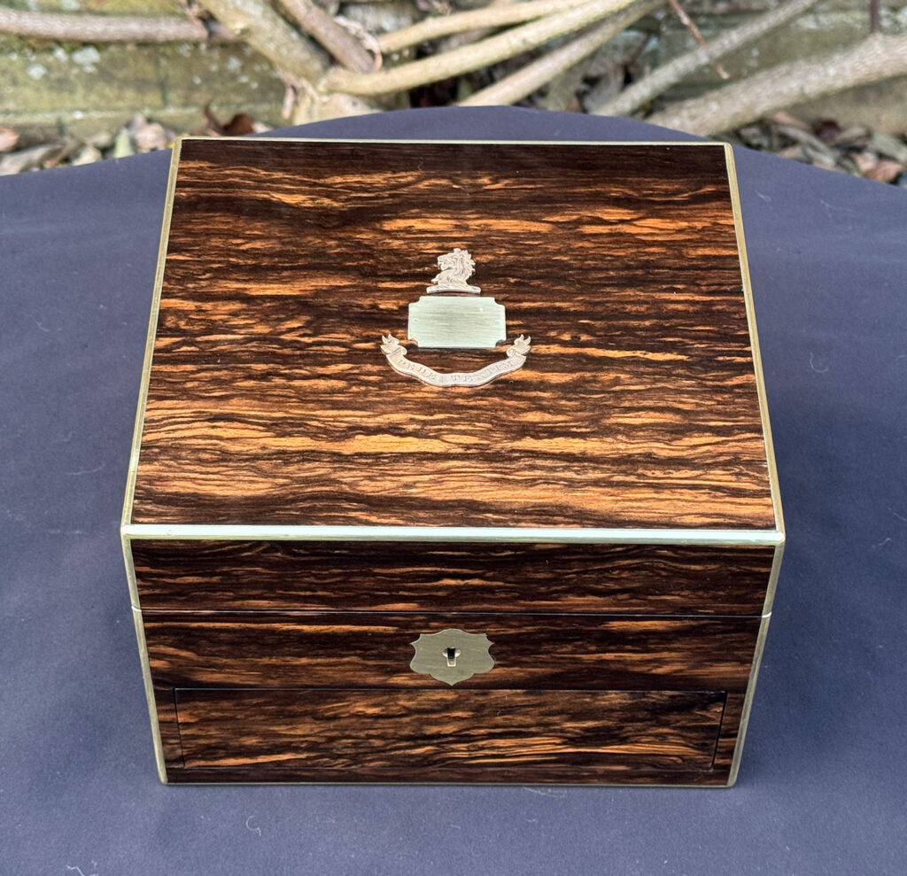 Overhead view of a miniature antique jewellery box in coromandel, by George Betjemann & Sons.