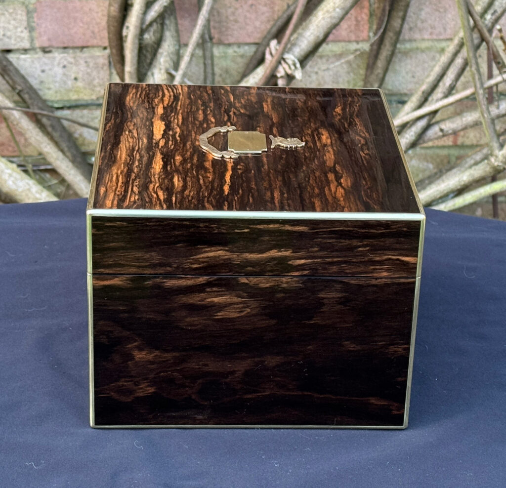 Right side view of a miniature antique jewellery box in coromandel, by George Betjemann & Sons.