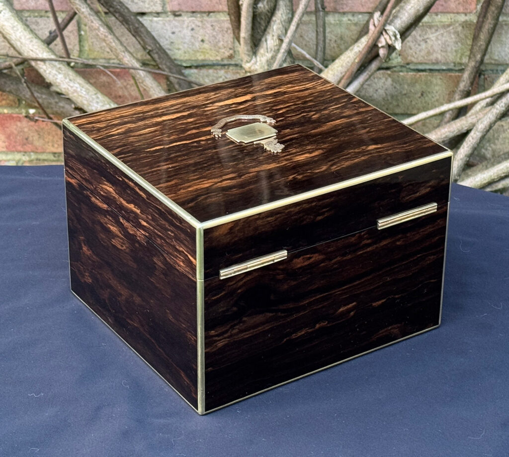 Rear right view of a miniature antique jewellery box in coromandel, by George Betjemann & Sons.