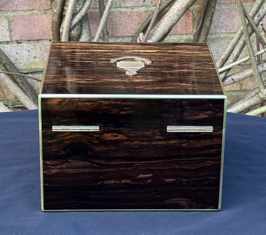 Rear view of a miniature antique jewellery box in coromandel, by George Betjemann & Sons.