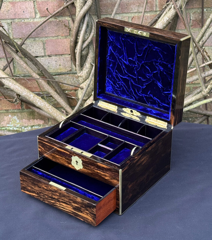 Front right internal view of a miniature antique jewellery box in coromandel, by George Betjemann & Sons, with drawer open.