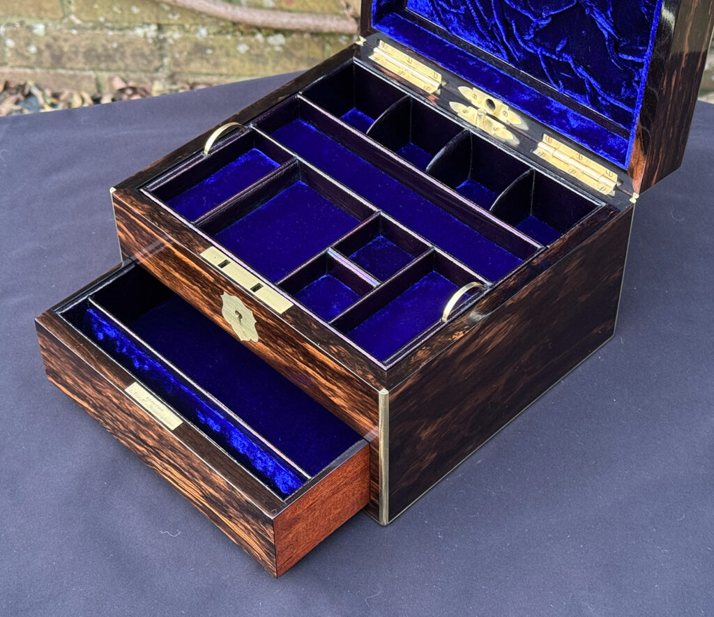 Closer internal view of a miniature antique jewellery box in coromandel, by George Betjemann & Sons, with drawer open