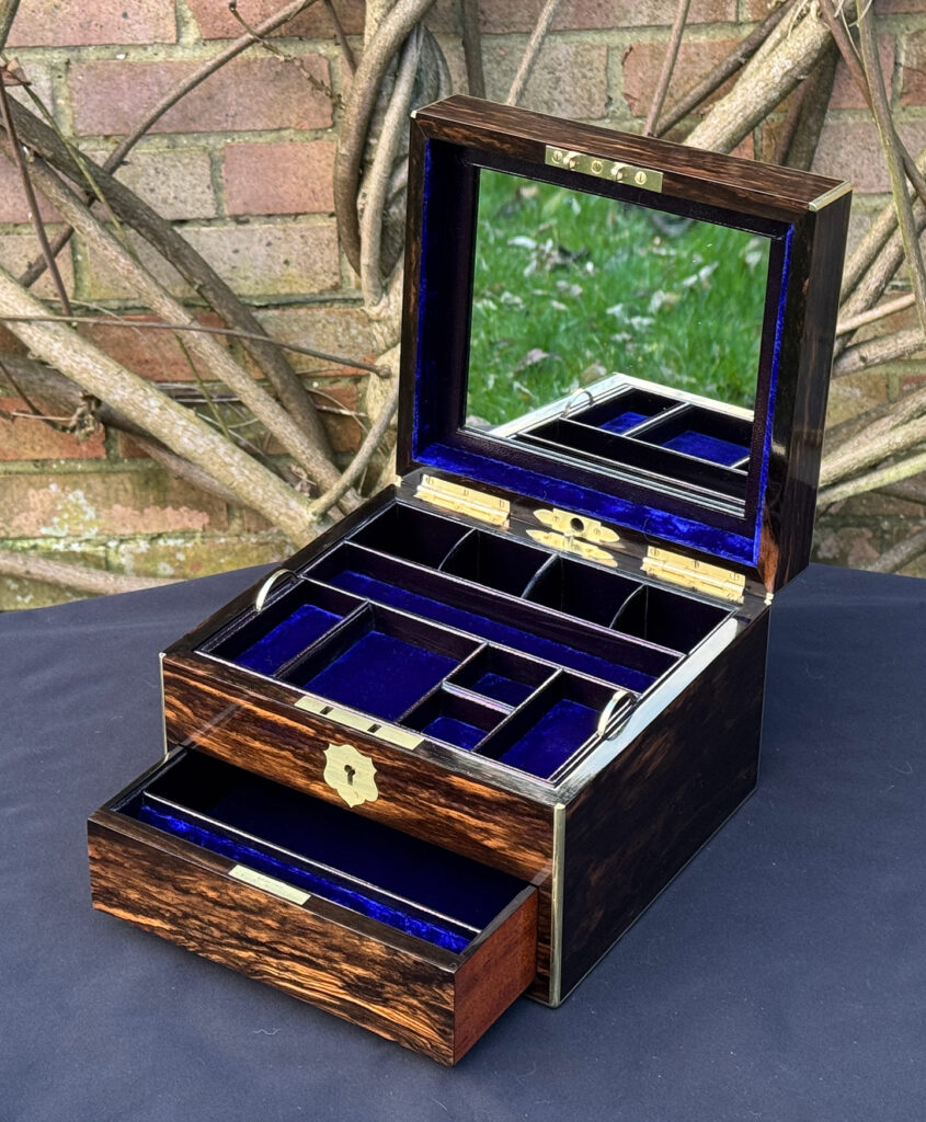 Front right internal view of a miniature antique jewellery box in coromandel, by George Betjemann & Sons, with mirror on display.