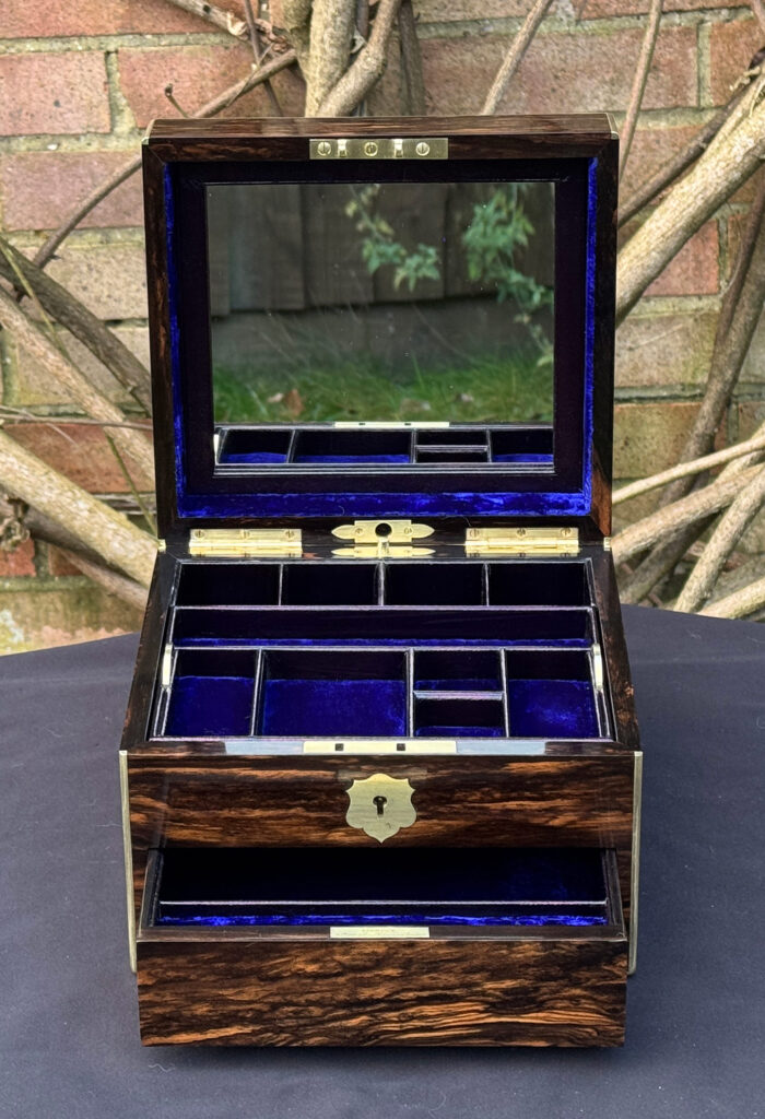 Front internal view of a miniature antique jewellery box in coromandel, by George Betjemann & Sons, with mirror on display.