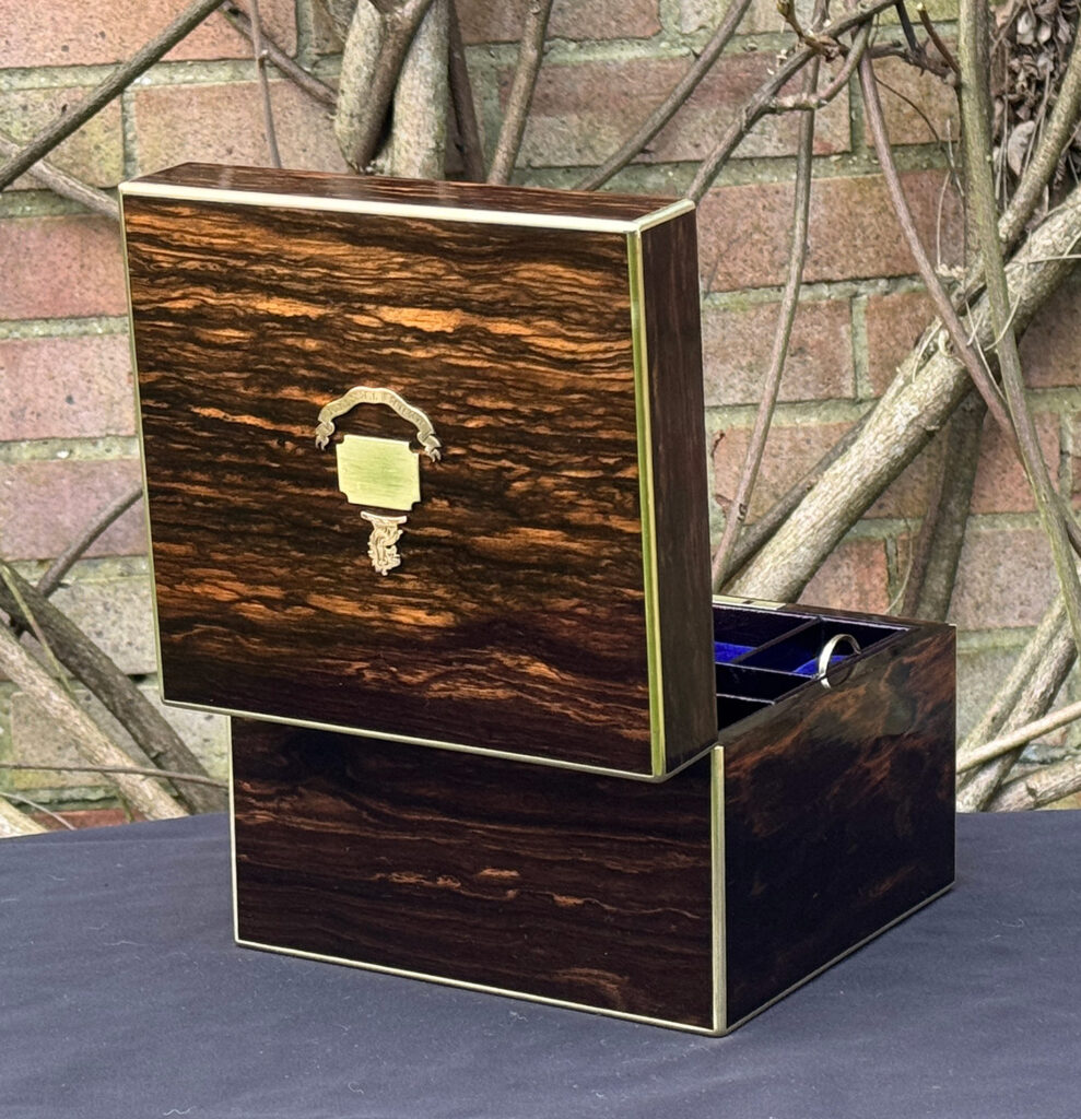 Rear opened view of a miniature antique jewellery box in coromandel, by George Betjemann & Sons.