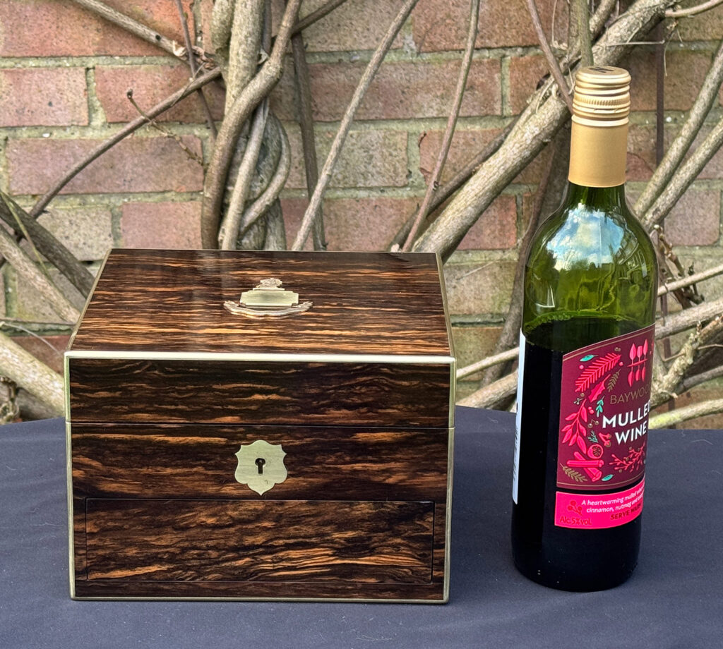 Size comparison view of a miniature antique jewellery box in coromandel, by George Betjemann & Sons.