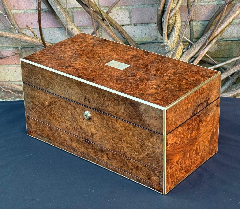 Front right view of a large antique jewellery box in burr walnut.