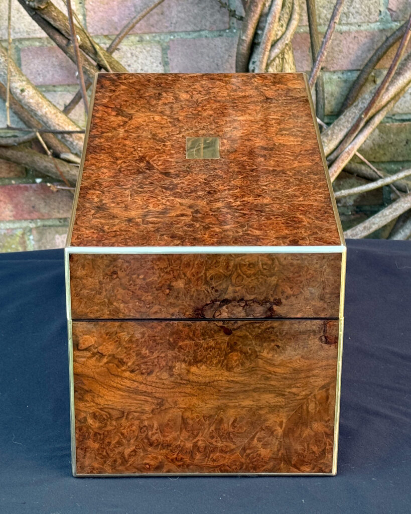 Right side view of a large antique jewellery box in burr walnut.