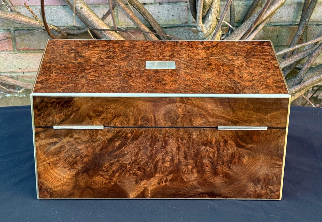 Rear view of a large antique jewellery box in burr walnut.