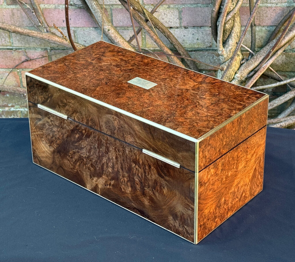 Rear left view of a large antique jewellery box in burr walnut.