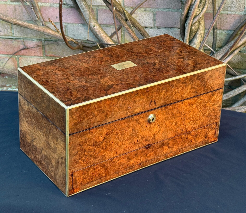 Rear right view of a large antique jewellery box in burr walnut.