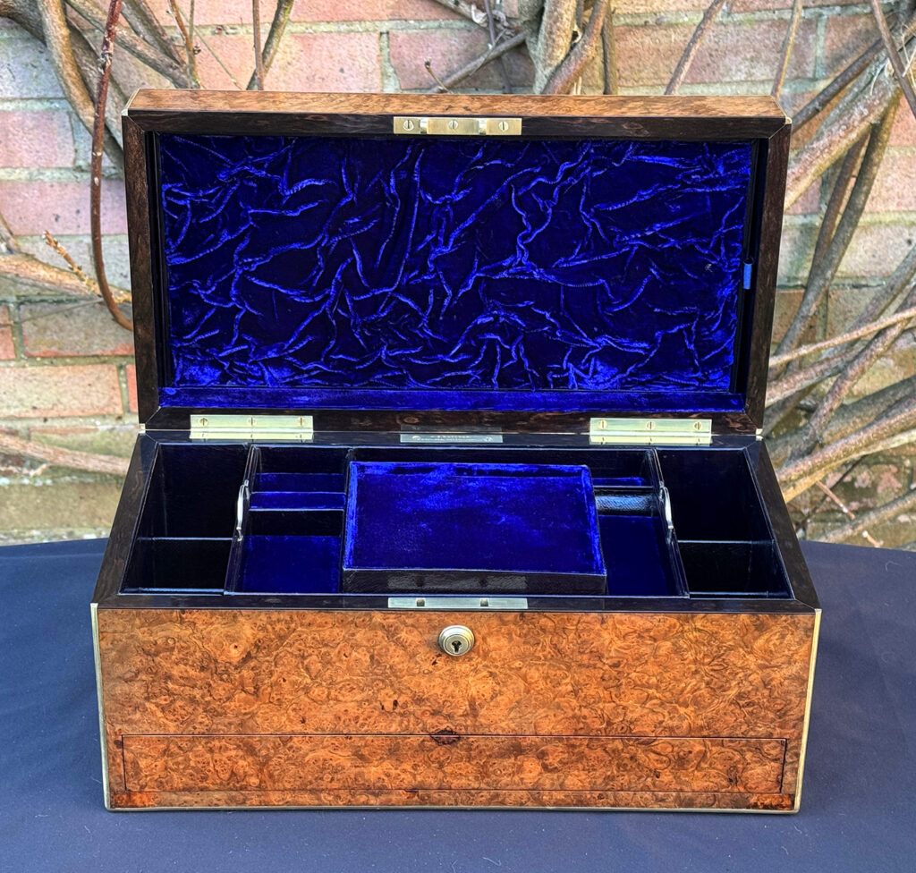 Front internal view of a large antique jewellery box in burr walnut.