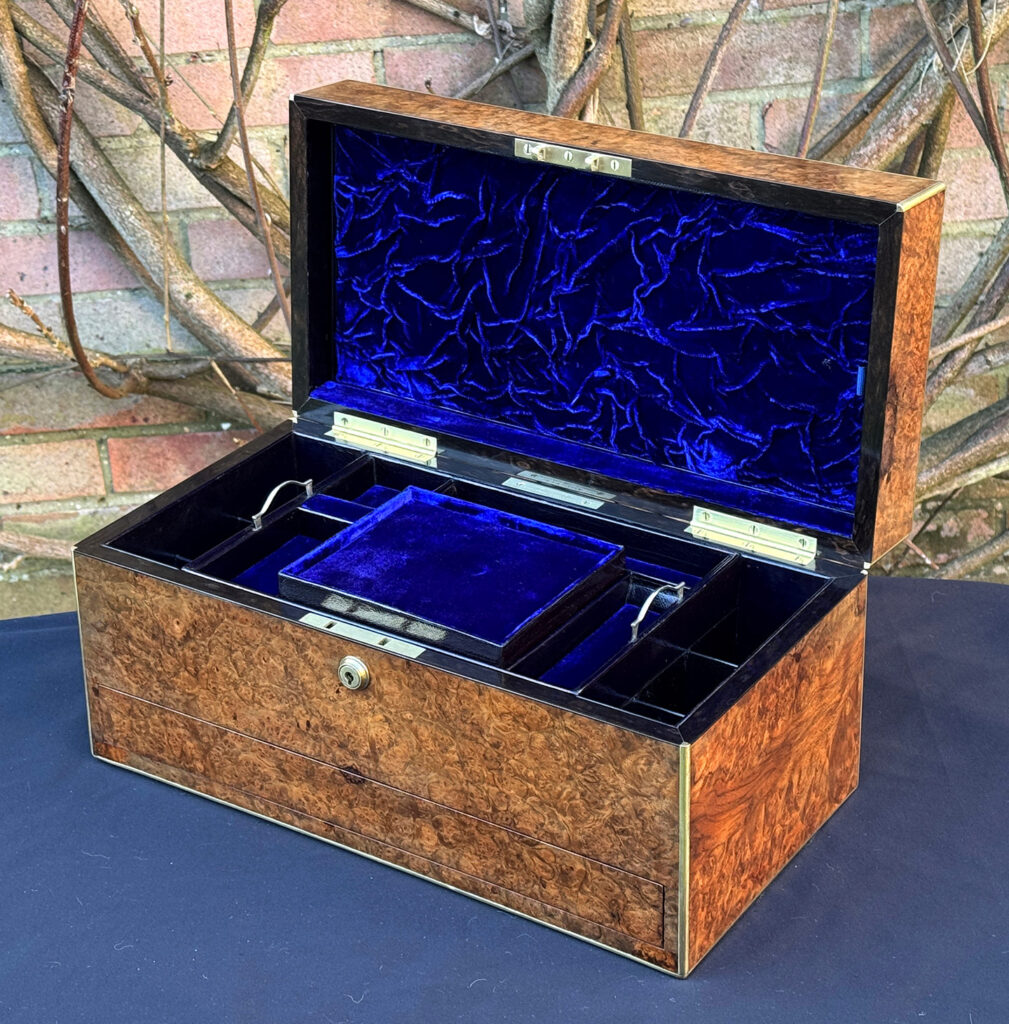 Front right internal view of a large antique jewellery box in burr walnut.