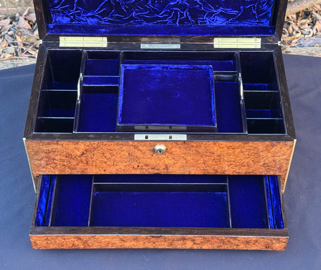 Overhead view of a large antique jewellery box in burr walnut.