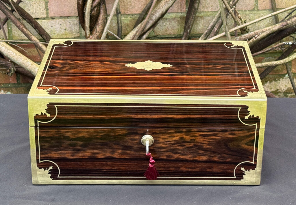 Front view of an antique jewellery box in calamander, by George Lawrence.