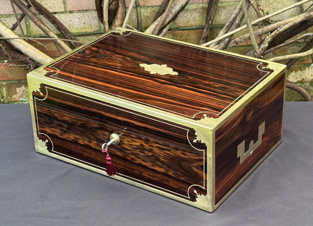 Front right view of an antique jewellery box in calamander, by George Lawrence.