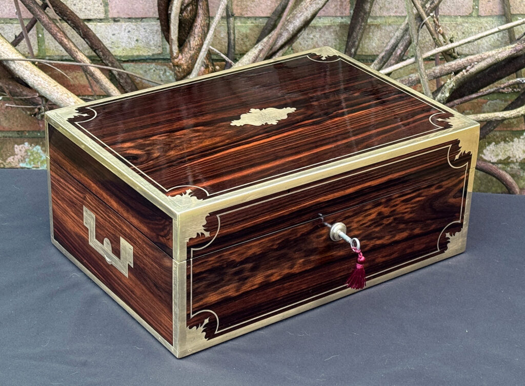 Front left view of an antique jewellery box in calamander, by George Lawrence.