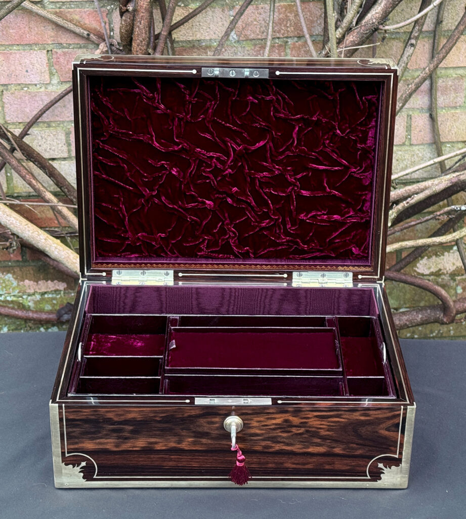 Front interior view of an antique jewellery box in calamander, by George Lawrence.