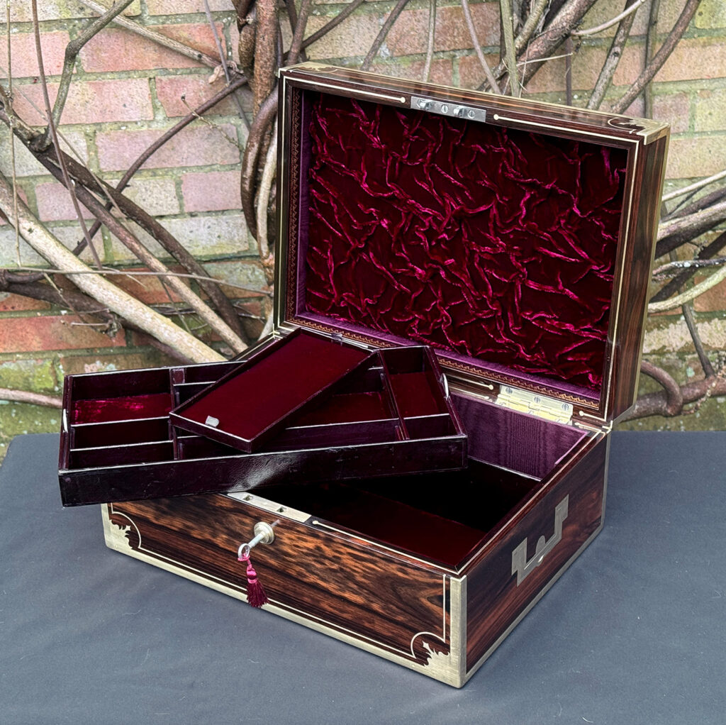 Front right interior view of an antique jewellery box in calamander, by George Lawrence, with trays removed.