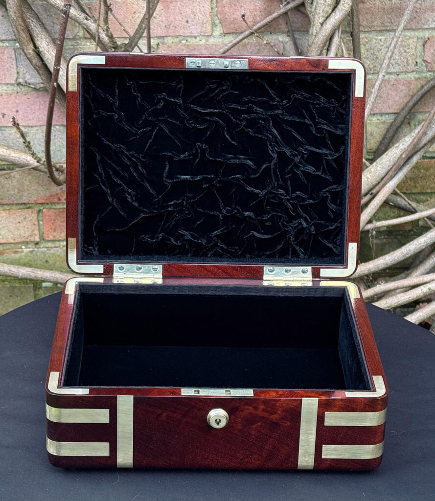 Front interior view of an antique radial edged travelling jewellery box in mahogany.