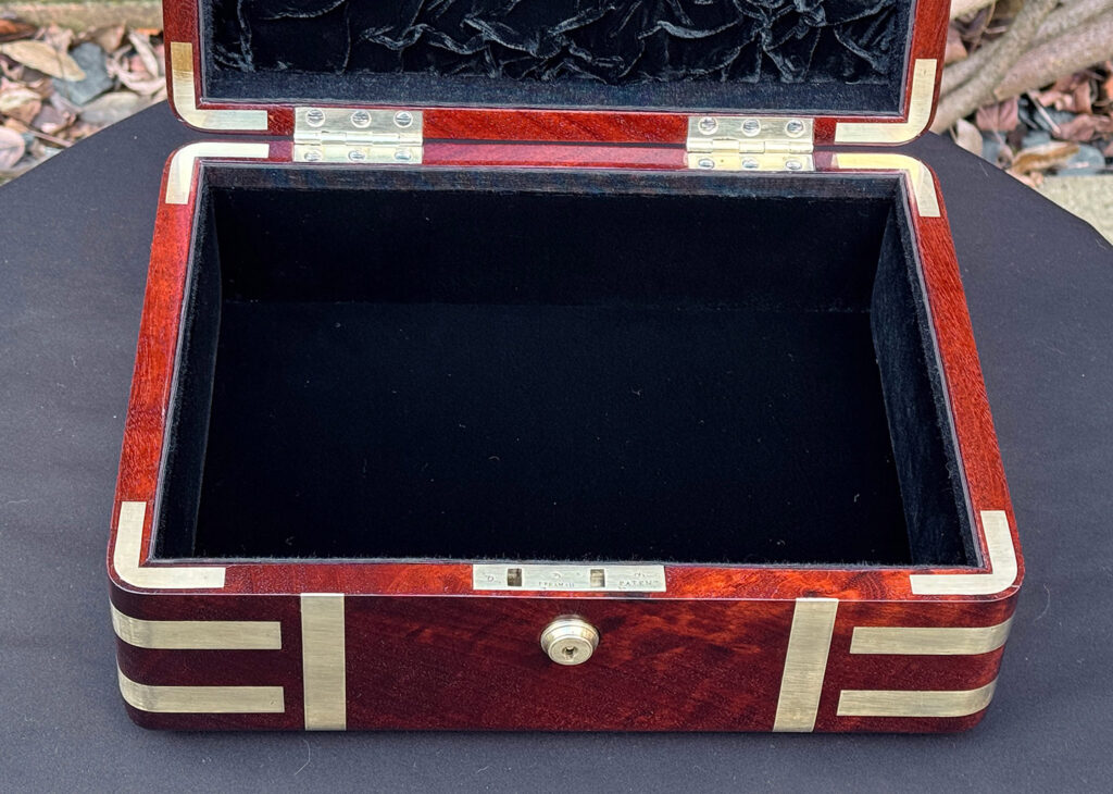 Another close interior view of an antique radial edged travelling jewellery box in mahogany.