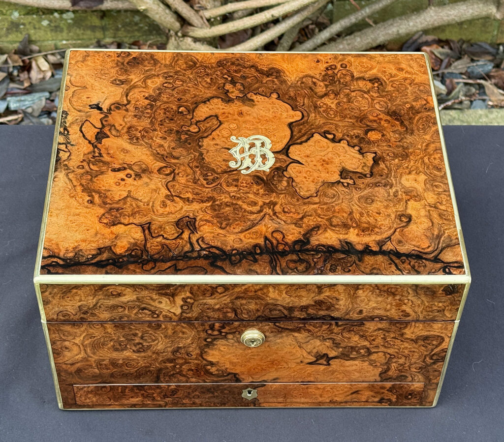 Overhead view of an antique jewellery box in burr walnut by Halstaff & Hannaford.