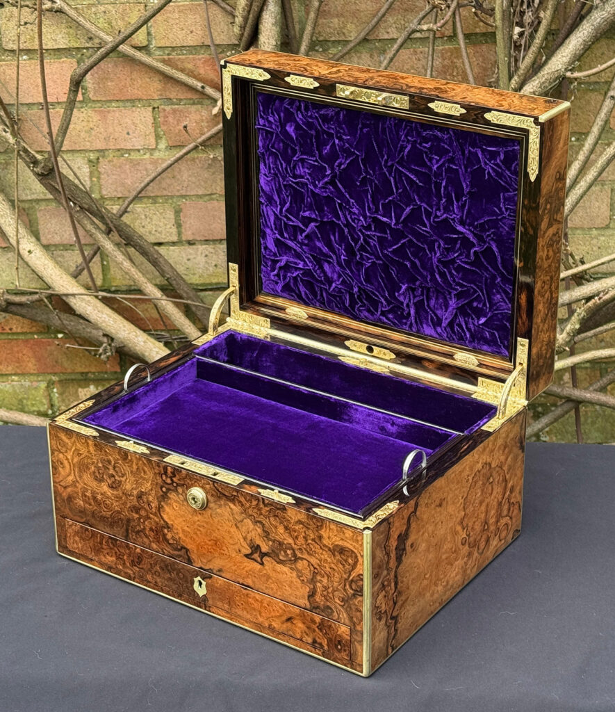 Front right interior view of an antique jewellery box in burr walnut by Halstaff & Hannaford.