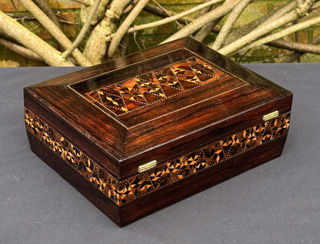 Rear right view of a small antique jewellery box in rosewood with parquetry inlay.