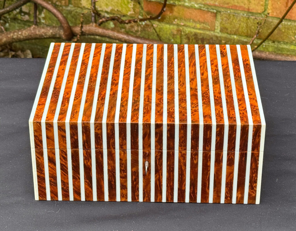 Front view of an antique Edwardian cigar box in thuya wood with ivory striped inlay.