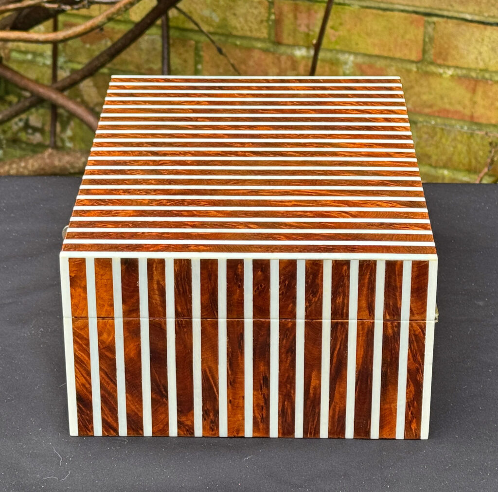 Right side view of an antique Edwardian cigar box in thuya wood with ivory striped inlay.