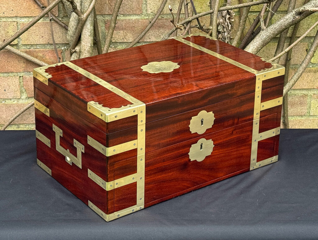Front left view of a large antique gentleman’s travelling jewellery box in Cuban mahogany, by Bayley & Blew.
