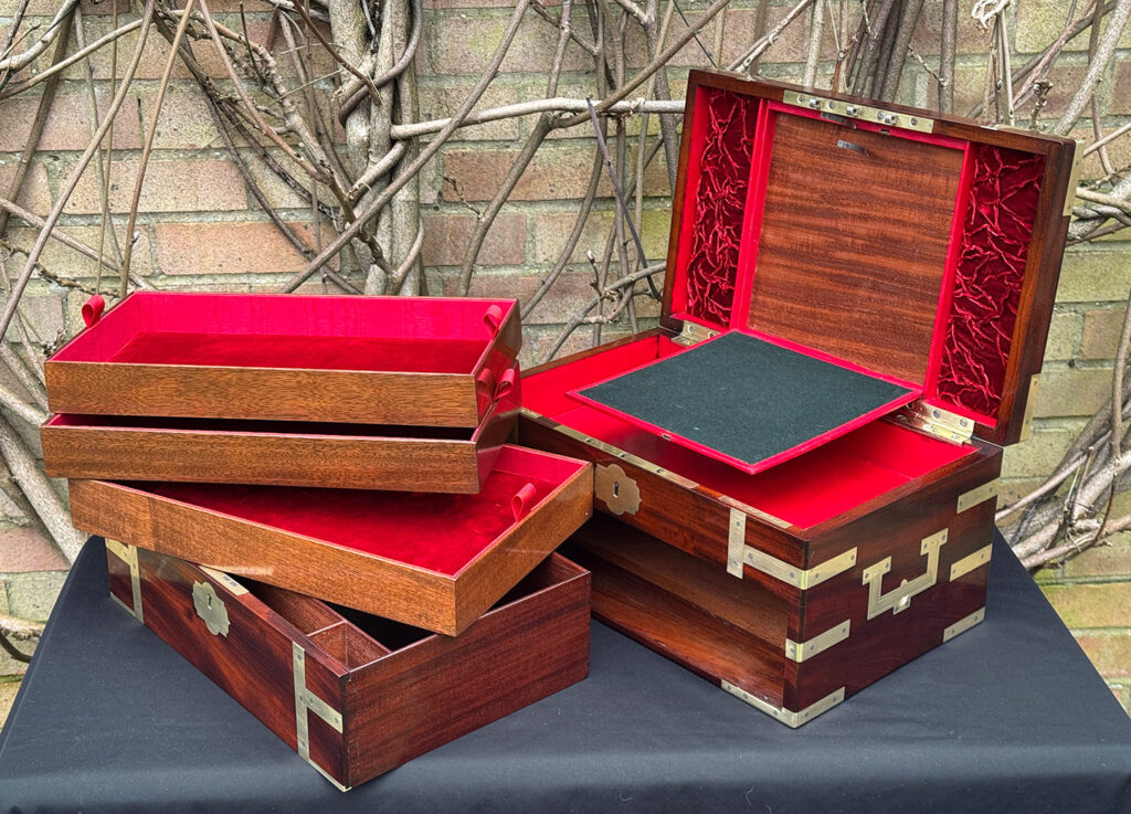 Interior view of a large antique gentleman’s travelling jewellery box in Cuban mahogany, by Bayley & Blew, with all trays removed and writing surface on display.