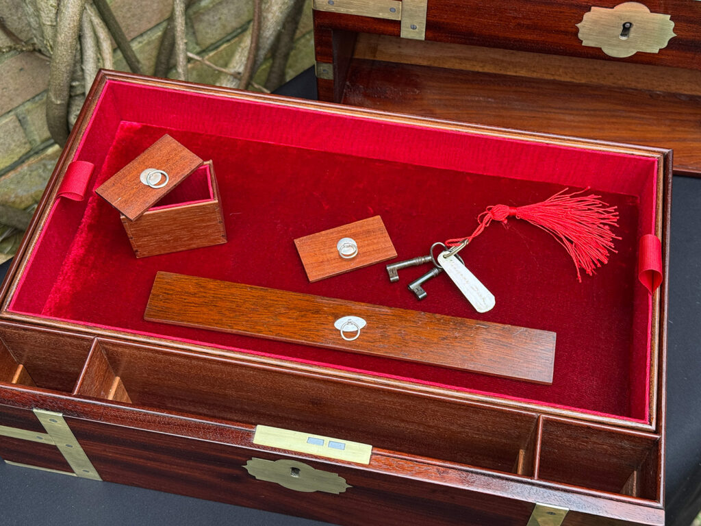 Close up view of the lower drawer fittings from a large antique gentleman’s travelling jewellery box in Cuban mahogany, by Bayley & Blew.