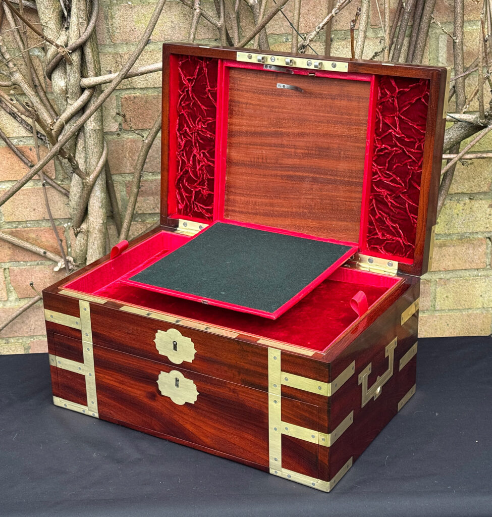 Front right interior view of a large antique gentleman’s travelling jewellery box in Cuban mahogany, by Bayley & Blew, with writing surface on display.