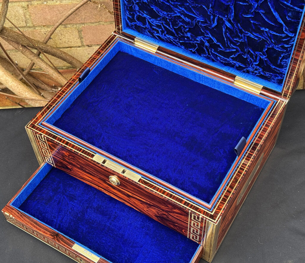Close interior view of an antique jewellery box in kingwood, by Wells & Lambe.