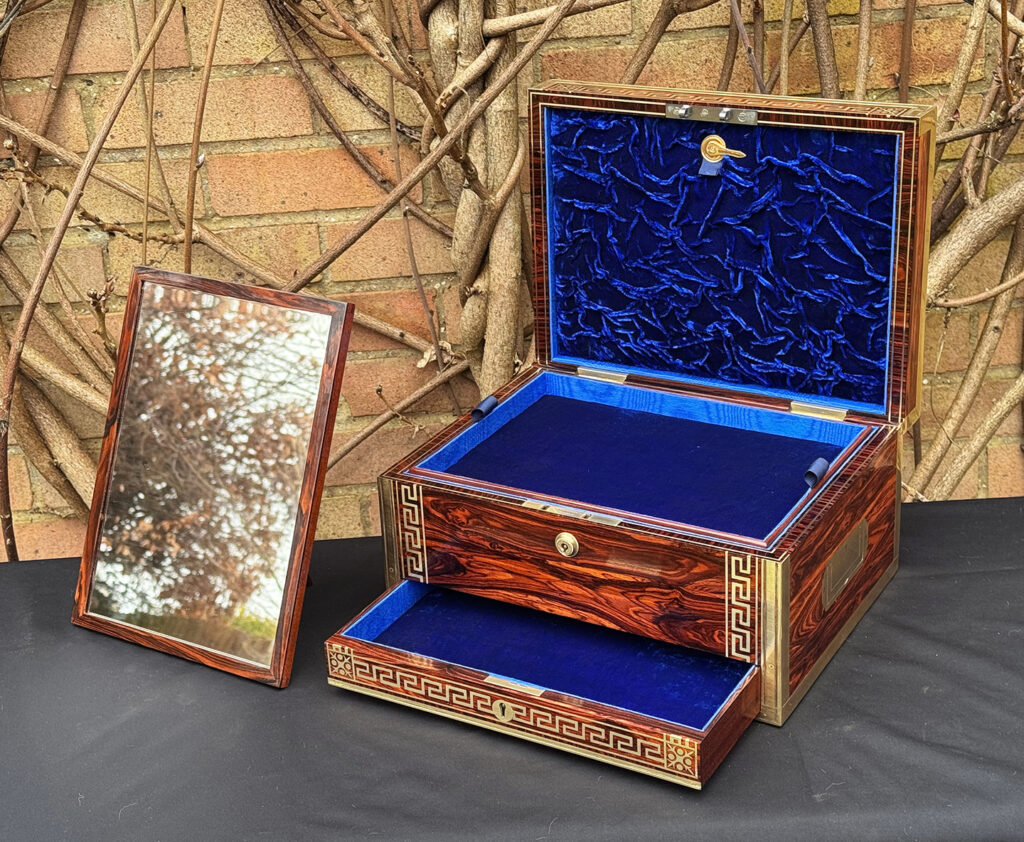 Front right interior view of an antique jewellery box in kingwood, by Wells & Lambe, with freestanding mirror on display.