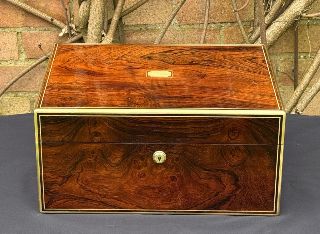 Front view of an antique jewellery box in rosewood, by Edwards.