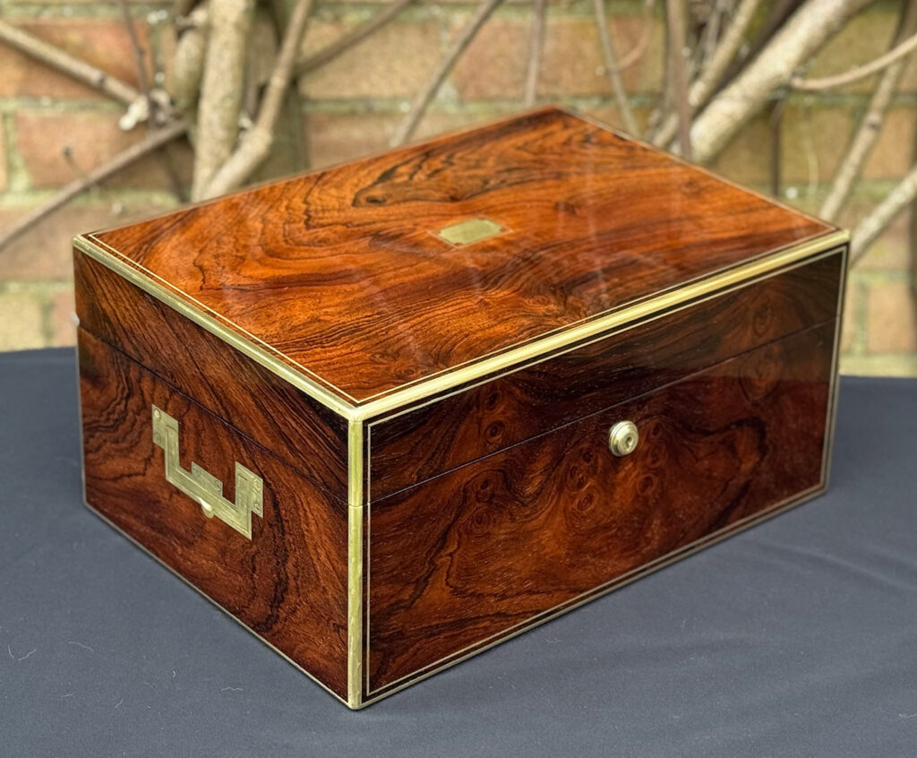 Front left view of an antique jewellery box in rosewood, by Edwards.