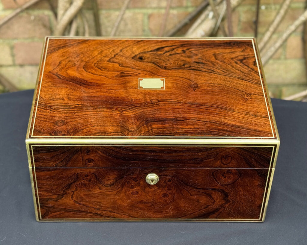Overhead view of an antique jewellery box in rosewood, by Edwards.