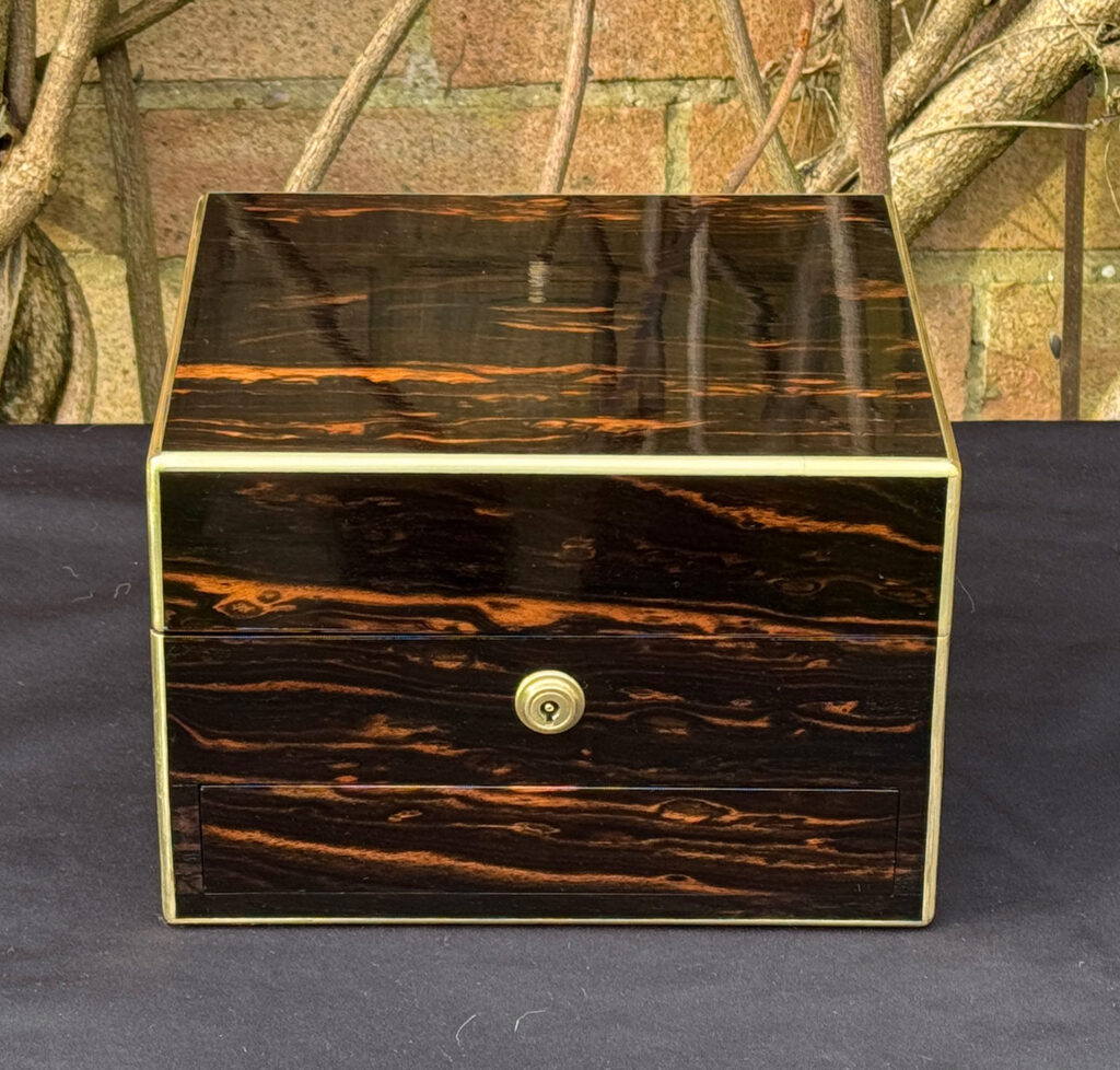 Front view of a rare miniature antique jewellery box in coromandel, by George Betjemann & Sons.
